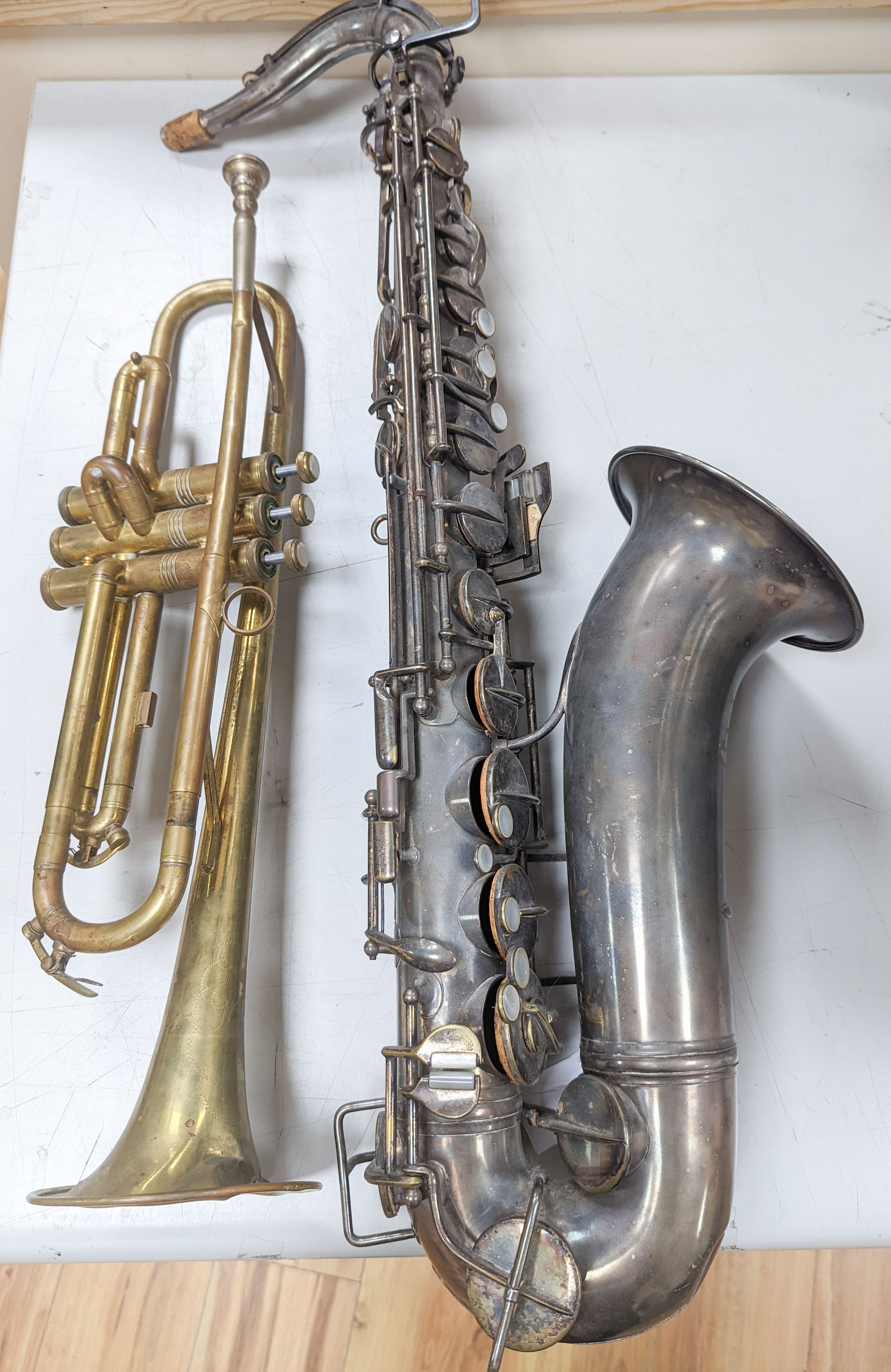 An Excelsior sonorous class A Hawkes & Son saxophone, and a Grafton Dallas, London trumpet with accessories